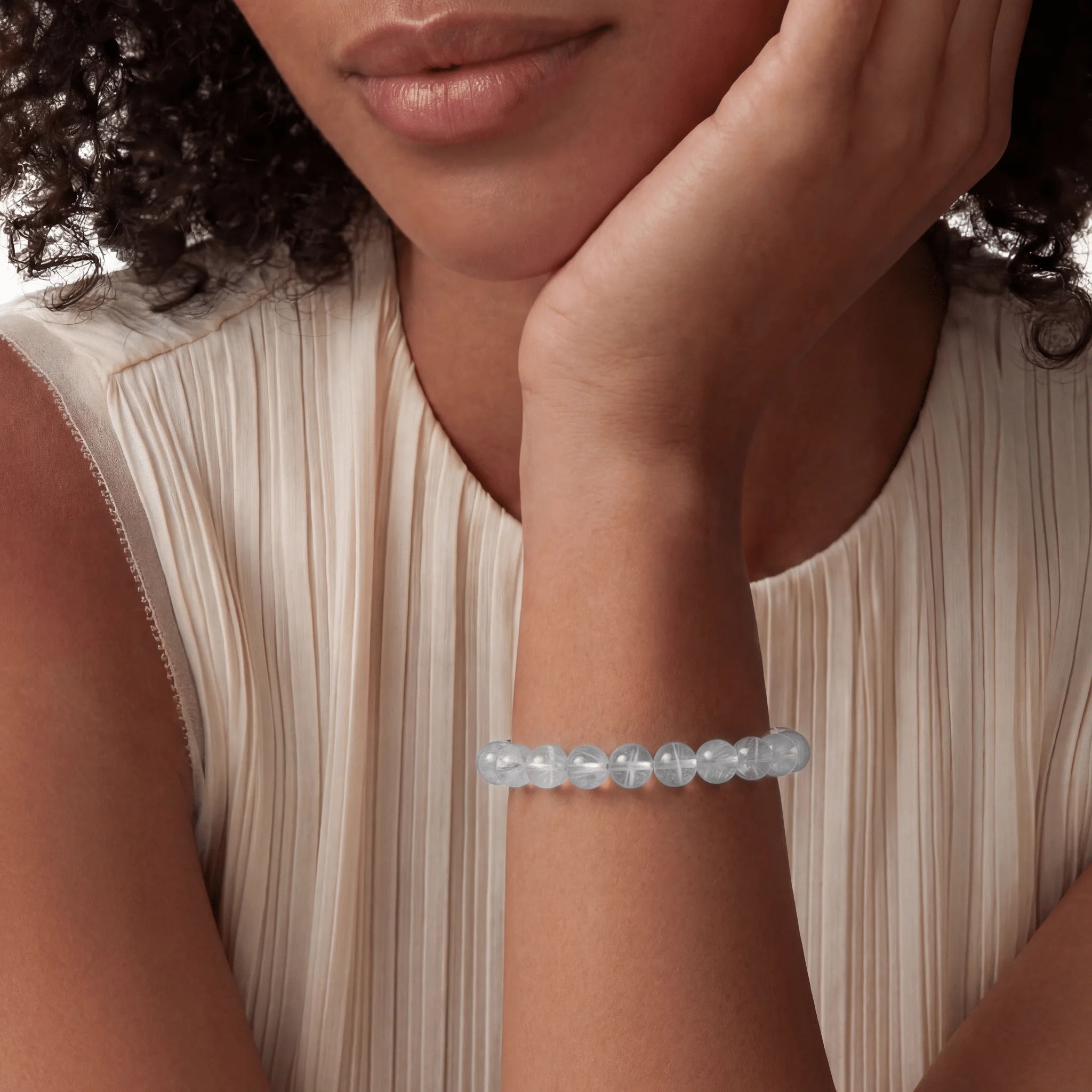 The Blue Needle Strand — Optical Architecture, bracelet on wrist, lifestyle model photo BE.