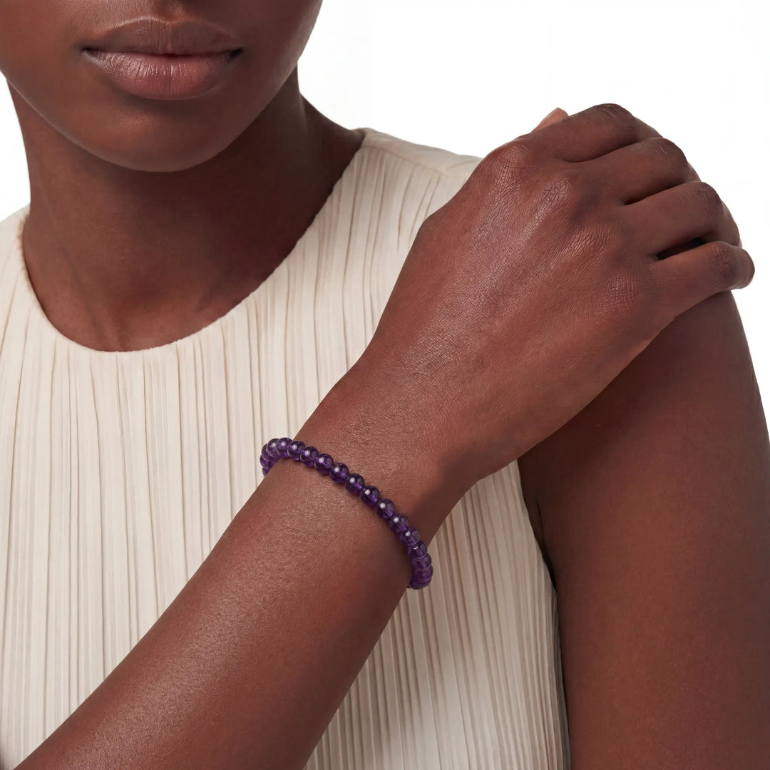 The 6mm Bolivian Amethyst Strand — The Void, bracelet worn on wrist, lifestyle model photo BE.