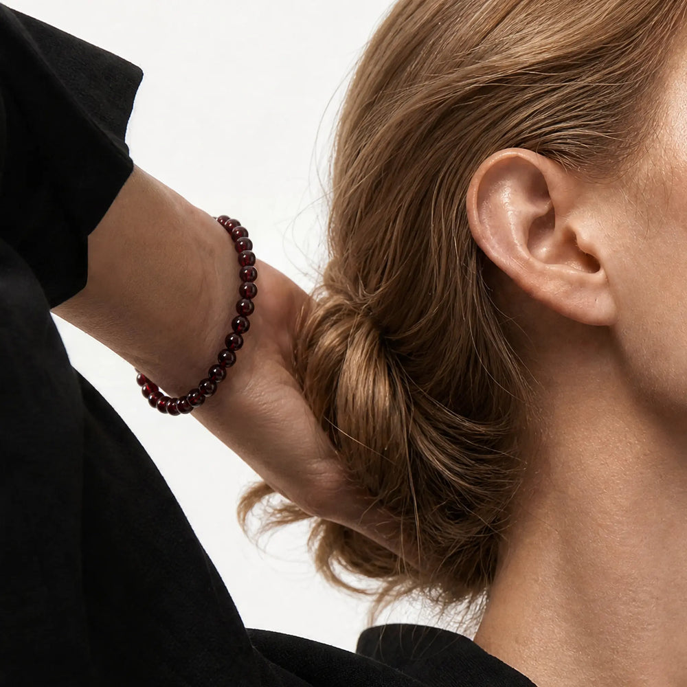 The Garnet Strand — Terrestrial Gravity, bracelet worn on wrist, lifestyle model photo BE.