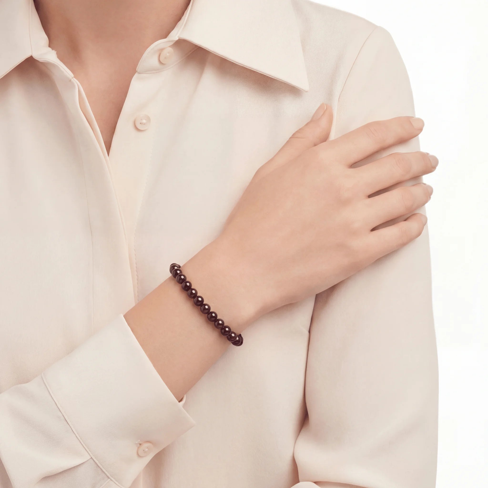 The Garnet Strand — Terrestrial Gravity, bracelet on wrist, lifestyle model photo BE.