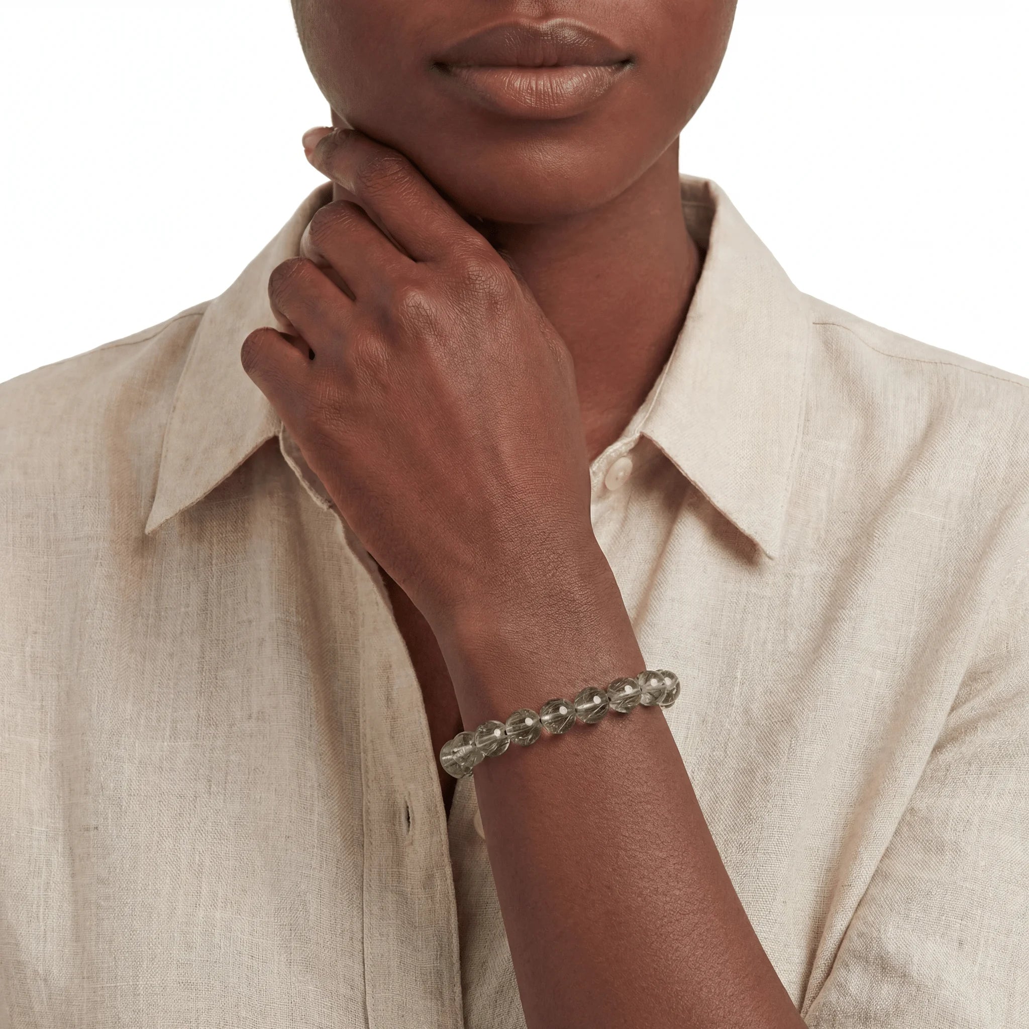 The Green Rutile Strand — Mineral Suspension, bracelet worn on wrist, lifestyle model photo BE.