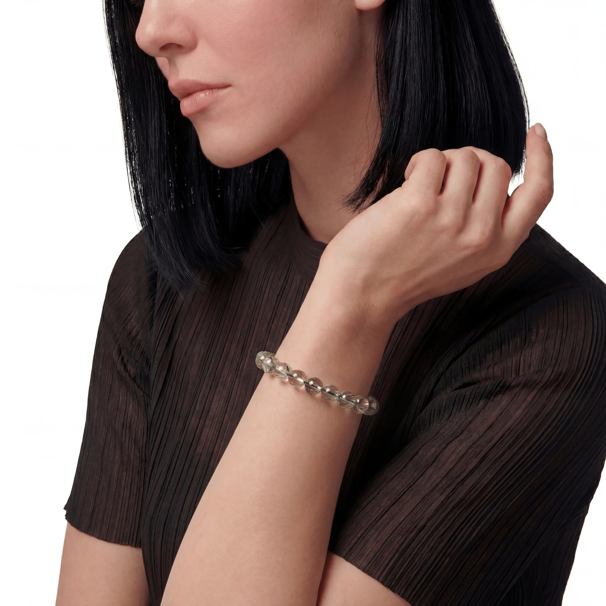 The Green Rutile Strand — Mineral Suspension, bracelet on wrist, lifestyle model photo BE.