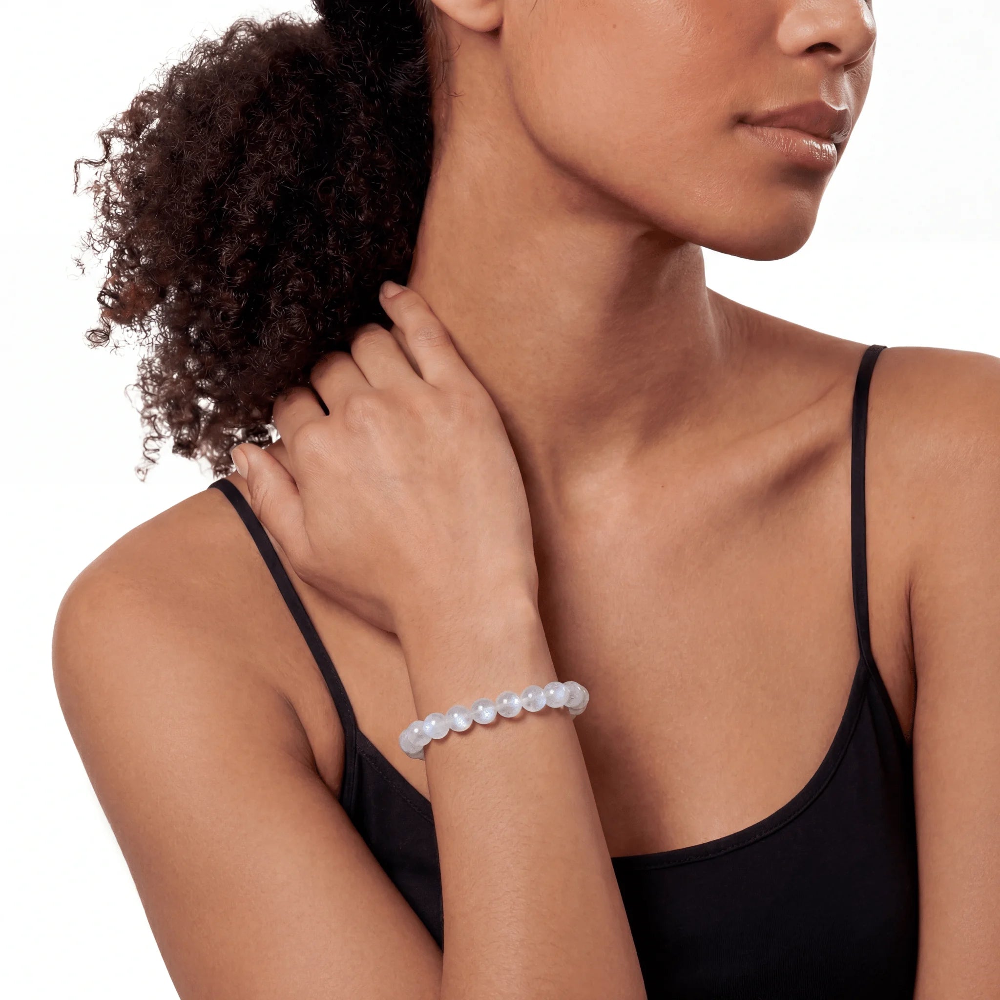 The Moonstone Strand — Luminous Phenomenon, bracelet worn on wrist, lifestyle model photo BE.