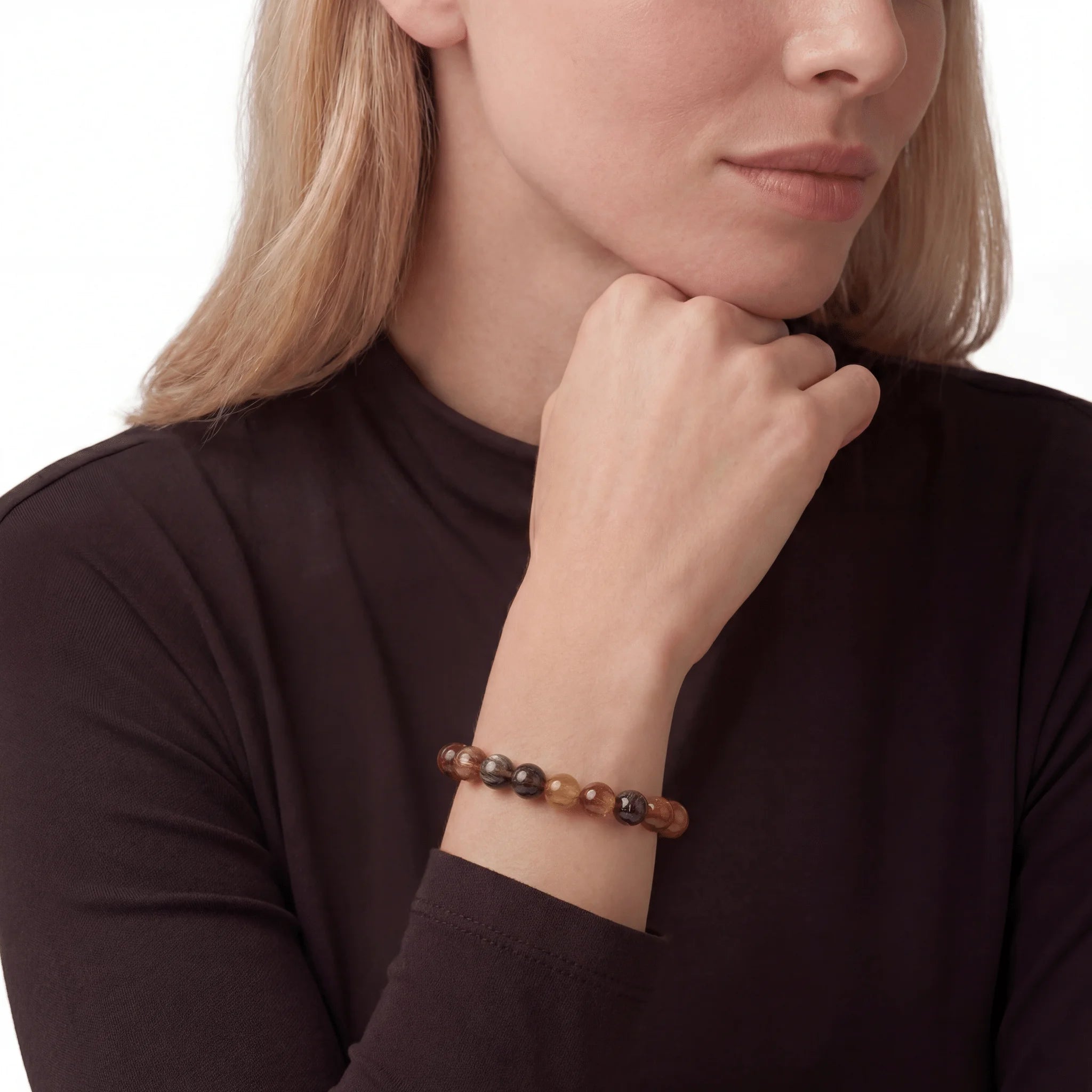 The Rutilated Quartz Strand — Titanium Sequence, bracelet on wrist, lifestyle model photo BE.