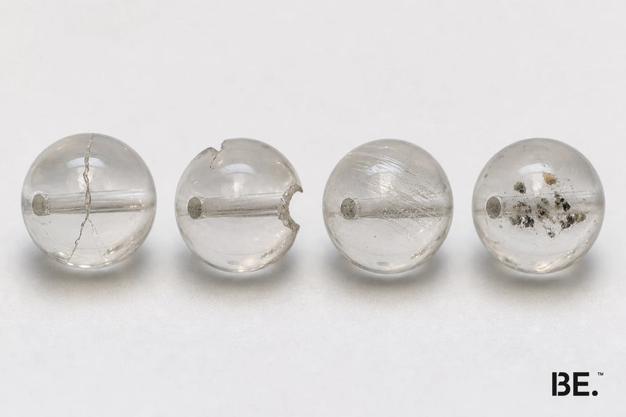 Four crystal bead observations comparing a surface crack, edge chip, scratch and internal inclusion — BE.