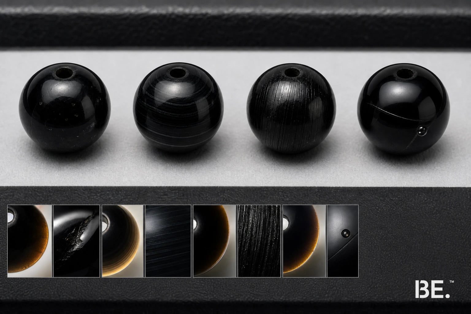 Four black beads comparing obsidian, onyx, tourmaline and manufactured glass clues — BE.