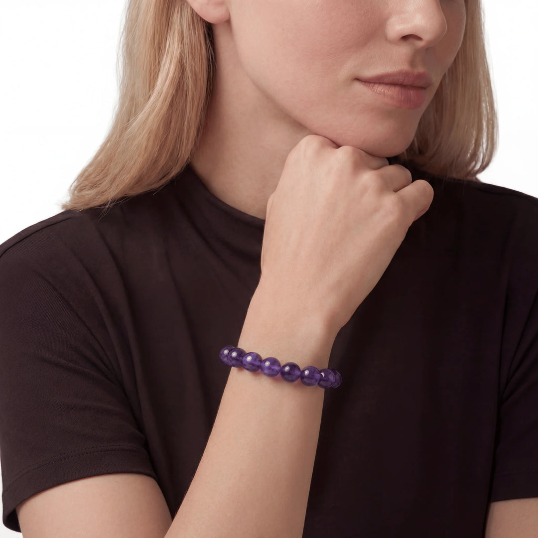 The Amethyst Strand — Bolivian Depth, bracelet worn on wrist, lifestyle model photo BE.