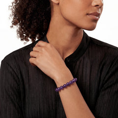 The Amethyst Strand — Bolivian Depth, bracelet on wrist, lifestyle model photo BE.