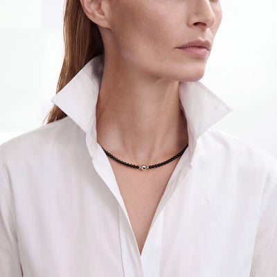 Black Onyx necklace worn with a white shirt, front view