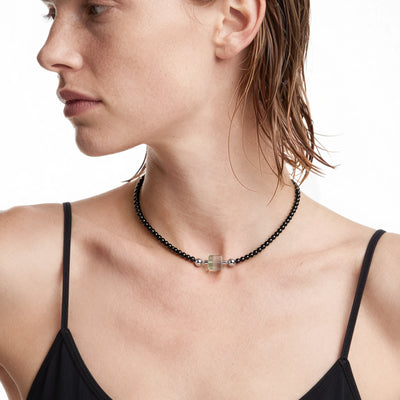 BE. Emerald Phantom Quartz Keystone worn on a 4 mm Black Onyx Necklace, on-body view