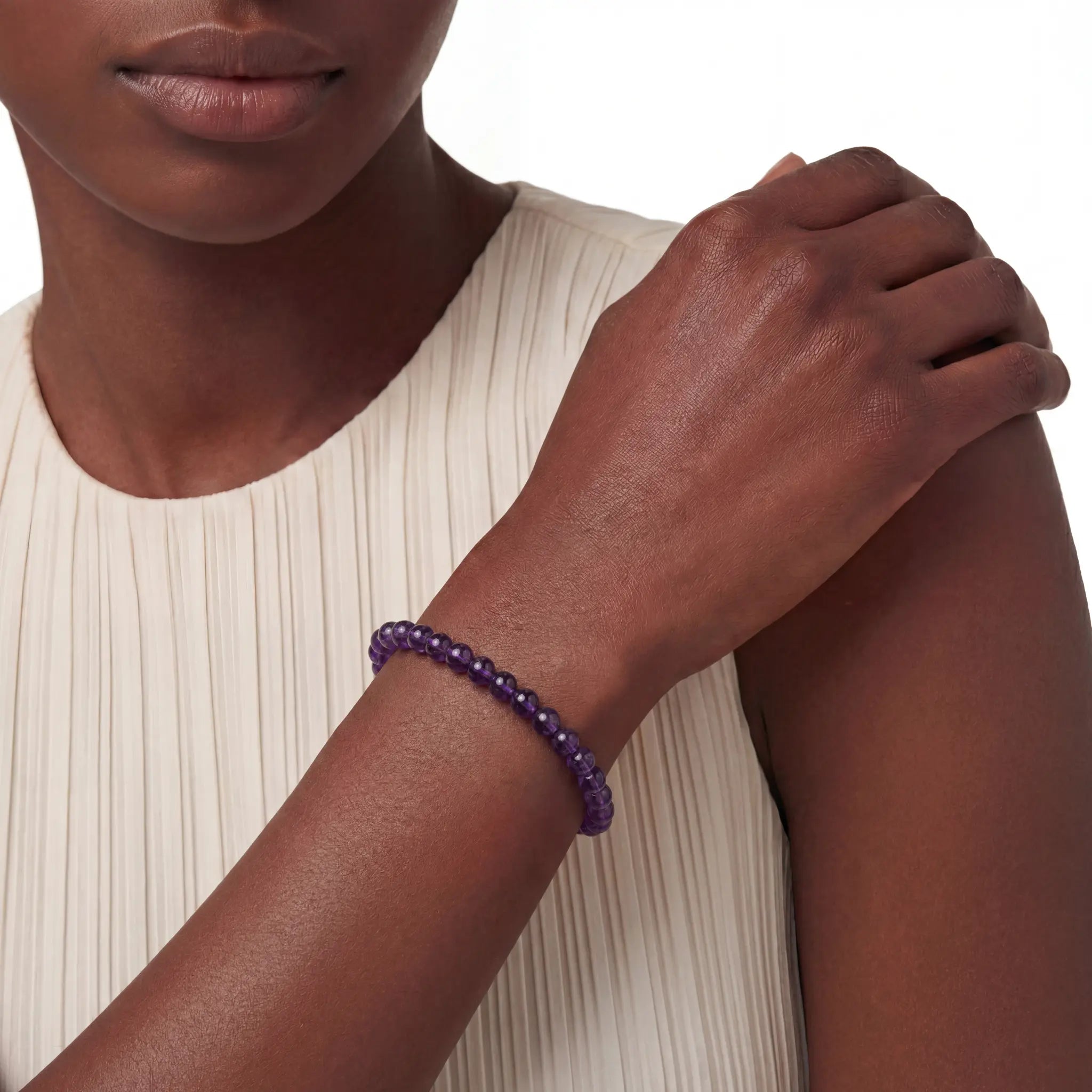 The 6mm Bolivian Amethyst Strand — The Void, bracelet worn on wrist, lifestyle model photo BE.