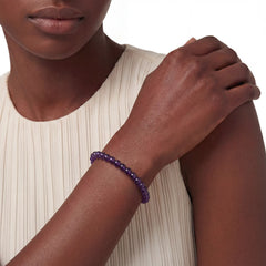 The 6mm Bolivian Amethyst Strand — The Void, bracelet worn on wrist, lifestyle model photo BE.