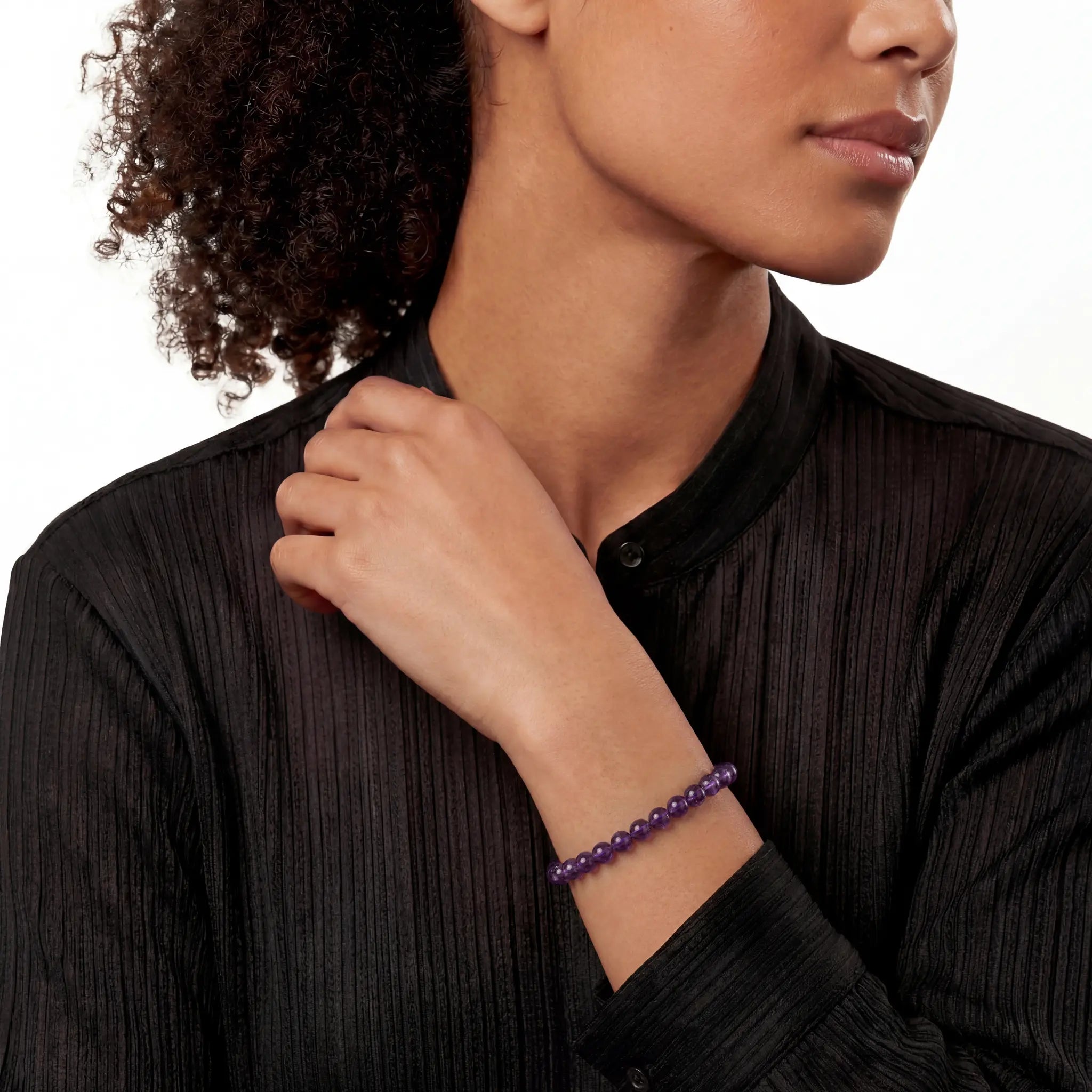 The 6mm Bolivian Amethyst Strand — The Void, bracelet on wrist, lifestyle model photo BE.