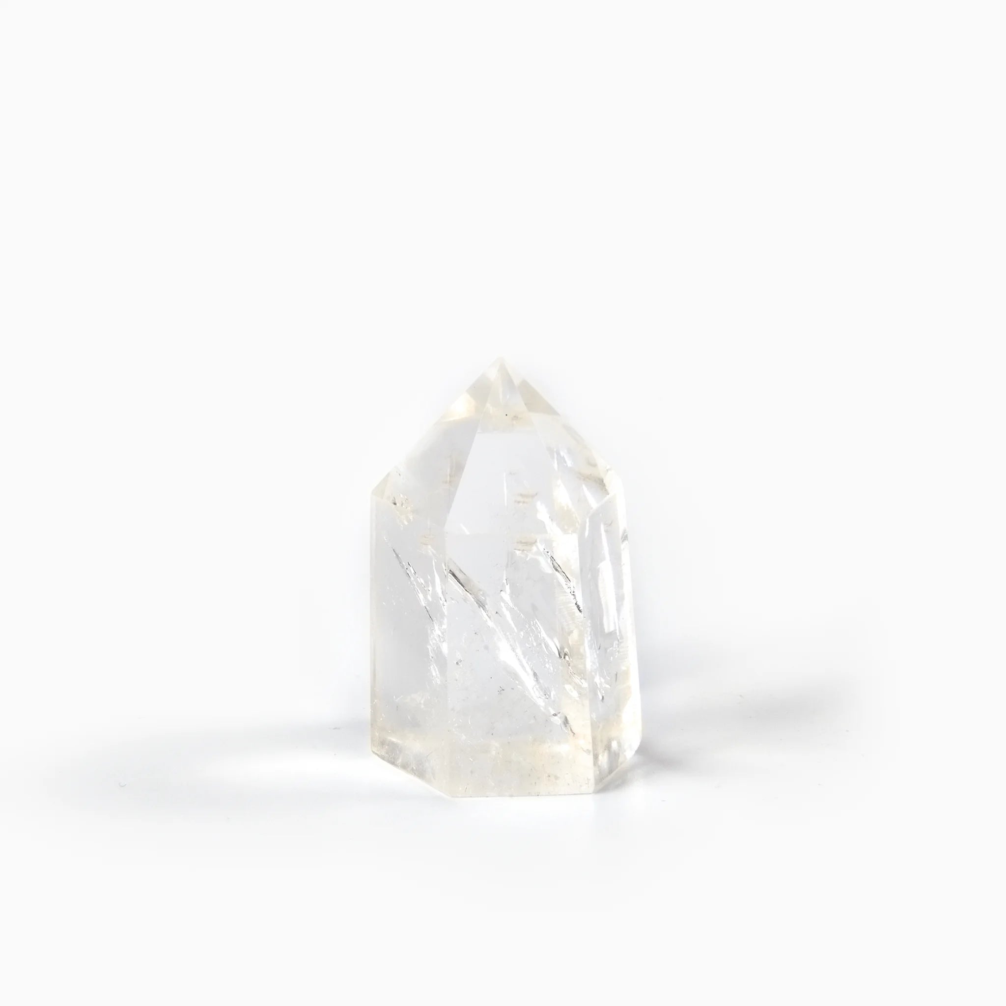The Clear Quartz Point — Single-Terminated, crystal point on white background BE.