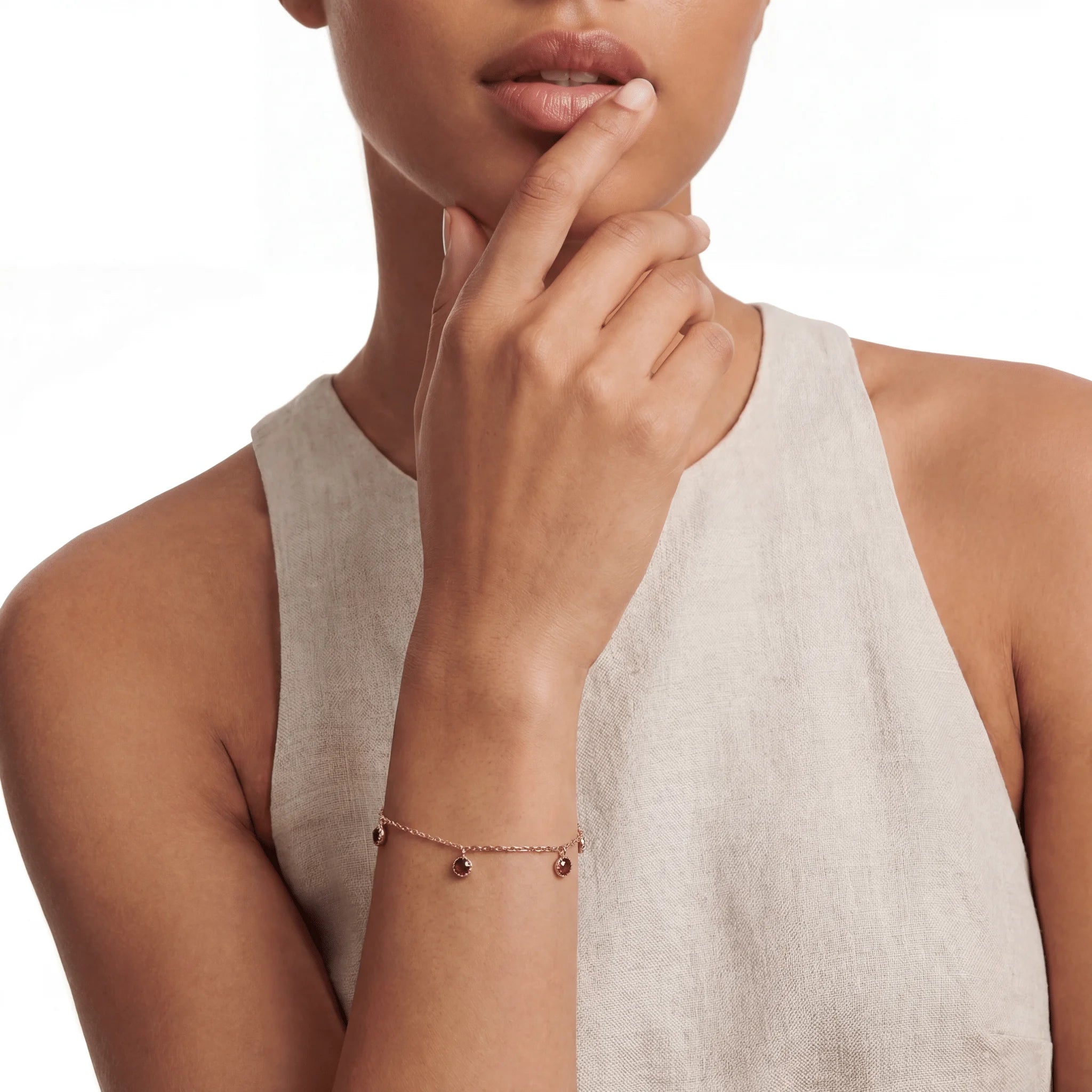 The Garnet Sequence — 18KT Gold Vermeil, bracelet worn on wrist, lifestyle model photo BE.