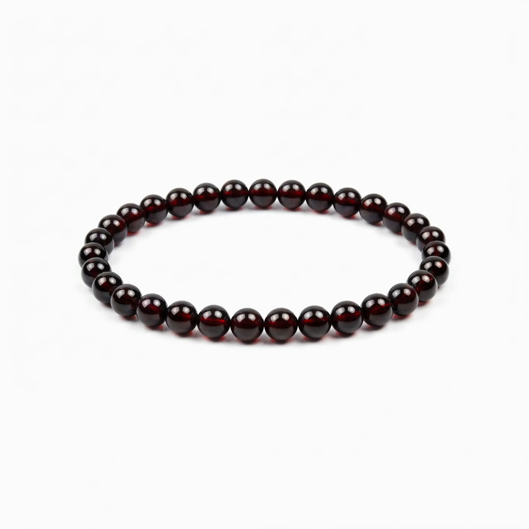 The Garnet Strand — Terrestrial Gravity, bracelet on white background BE.