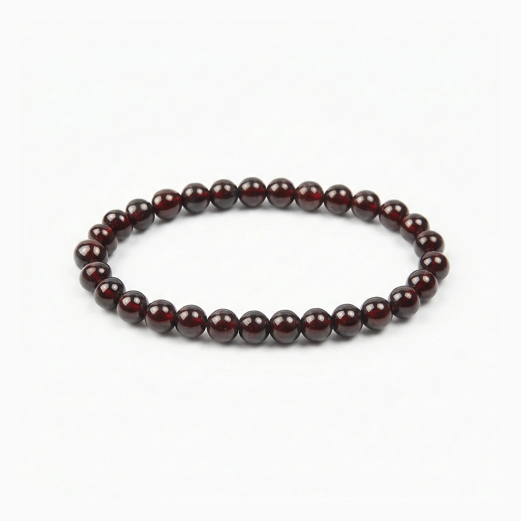 The Garnet Strand — Terrestrial Gravity, bracelet on white background BE.