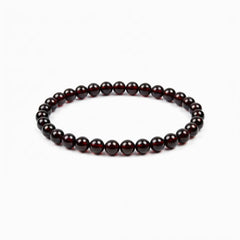 The Garnet Strand — Terrestrial Gravity, bracelet on white background BE.