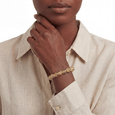 Golden Rutilated Quartz Powerflow Bracelet, bracelet on wrist, lifestyle model photo BE.