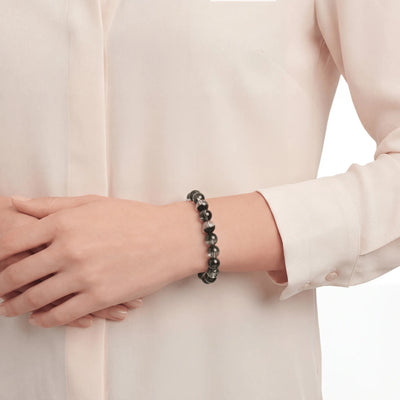 The Green Phantom Strand — Geological Sequence, bracelet worn on wrist, lifestyle model photo BE.