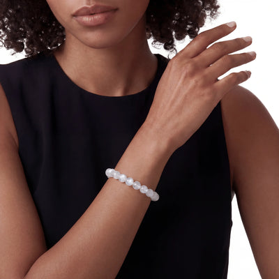 The Moonstone Strand — Luminous Phenomenon, bracelet on wrist, lifestyle model photo BE.