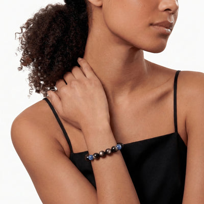 The Obsidian Strand — Cyan Hemisphere, bracelet worn on wrist, lifestyle model photo BE.