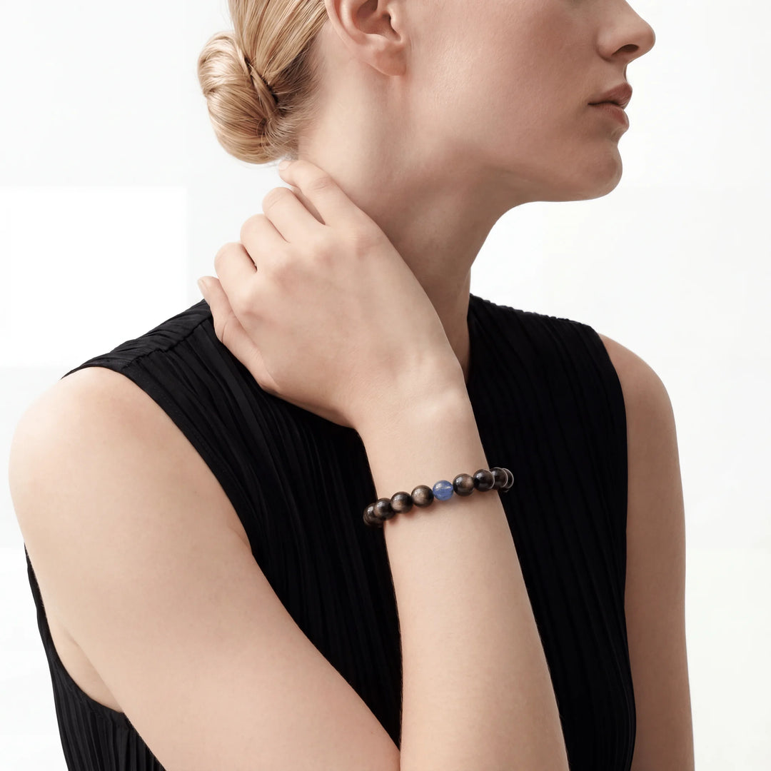 The Obsidian Strand — Cyan Hemisphere, bracelet on wrist, lifestyle model photo BE.
