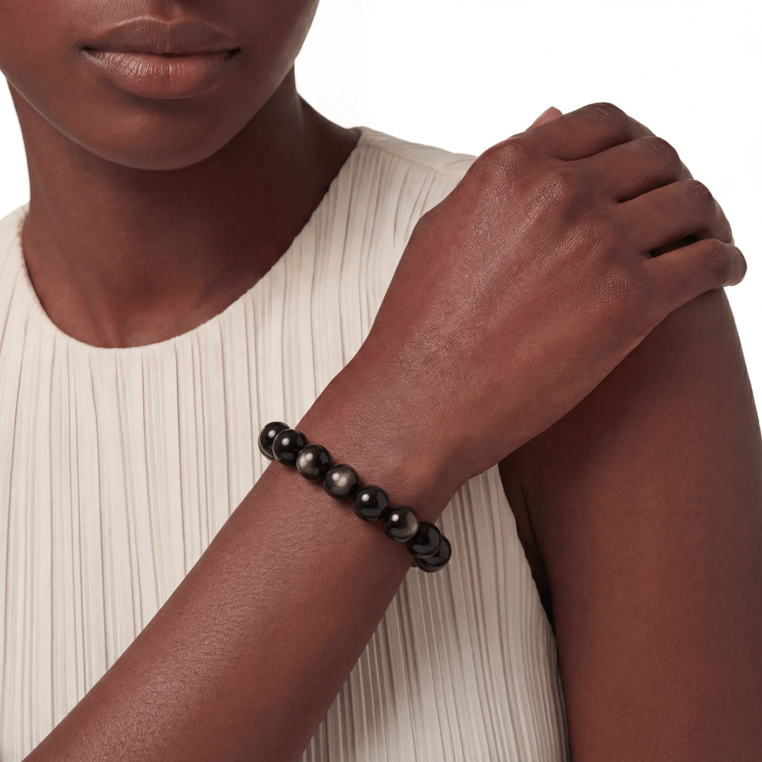 The Obsidian Strand — Gold Sheen, bracelet worn on wrist, lifestyle model photo BE.