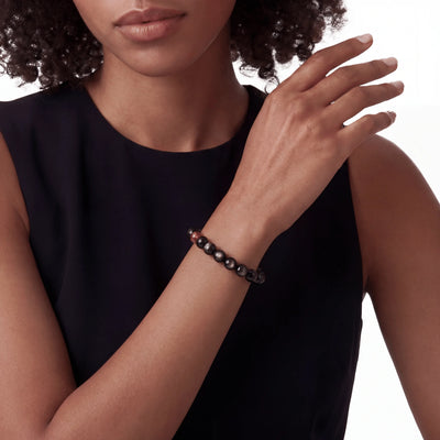 The Obsidian Strand — Iron Hemisphere, bracelet on wrist, lifestyle model photo BE.