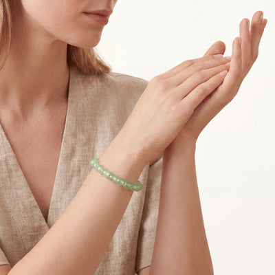 The Prehnite Strand — Luminous Matrix, bracelet worn on wrist, lifestyle model photo BE.