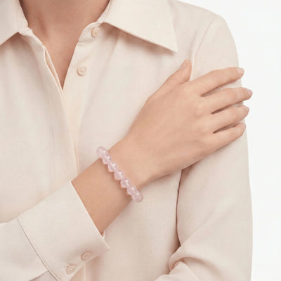 The Rose Quartz Strand — Serene Luminescence, bracelet on wrist, lifestyle model photo BE.