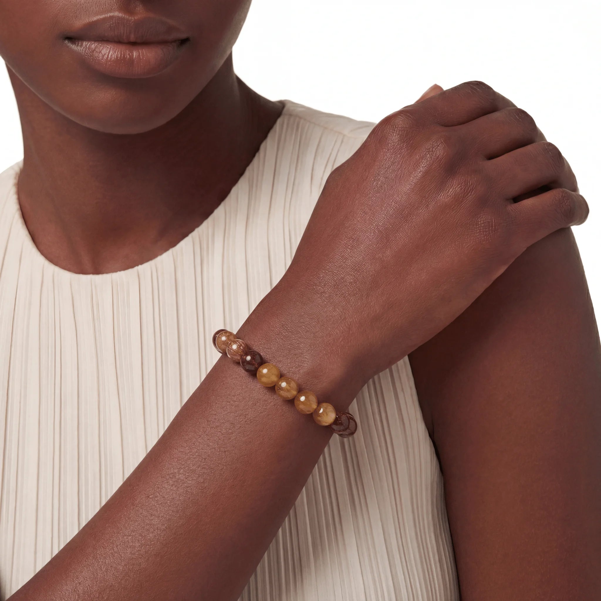 The Rutilated Quartz Strand — Titanium Sequence, bracelet worn on wrist, lifestyle model photo BE.