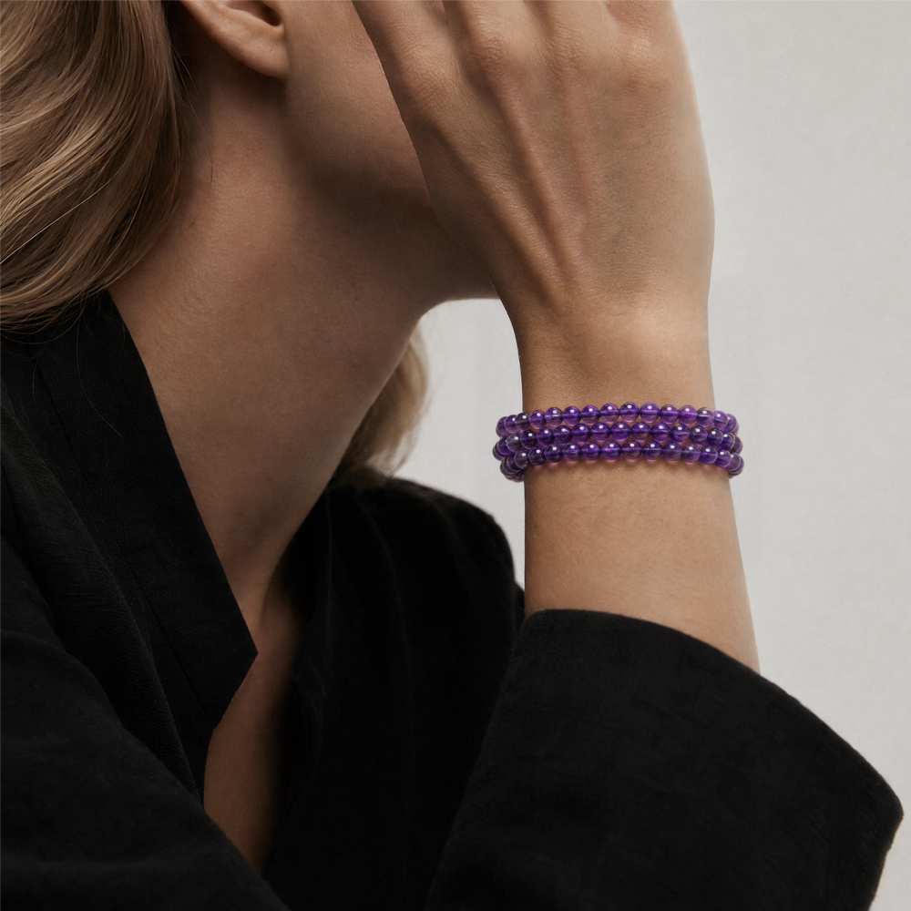 The Bolivian Amethyst Triple-Strand Bracelet Necklace worn layered at the wrist, BE.