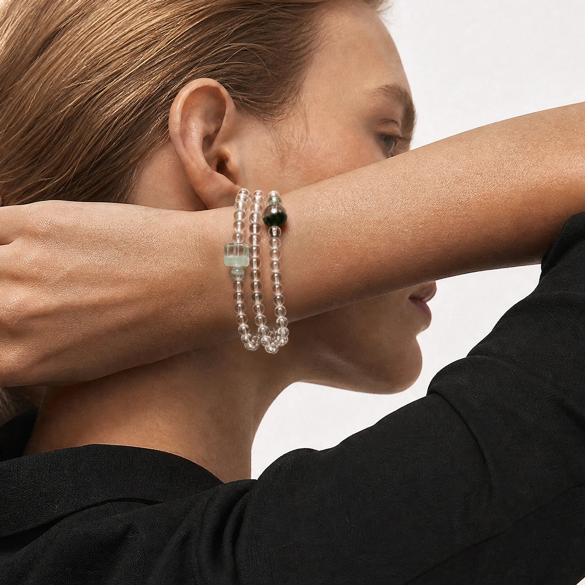 The Emerald Phantom Bracelet - Tri-Wire Architecture worn as a layered wrist structure, BE.