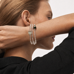 The Emerald Phantom Bracelet - Tri-Wire Architecture worn as a layered wrist structure, BE.