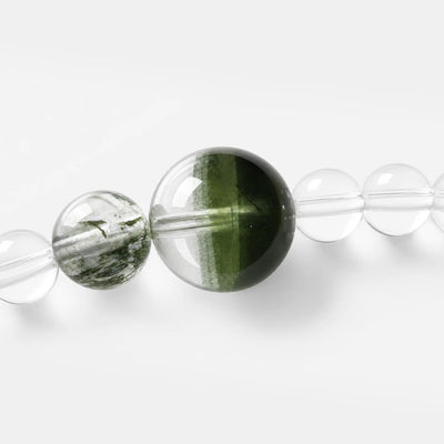 Emerald Phantom Tri-Wire Bracelet close-up — green phantom layers inside clear quartz, BE.