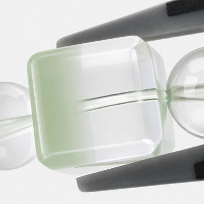 Emerald Phantom Cube Bracelet close-up — green phantom layers inside clear quartz cubes, angled view, BE.