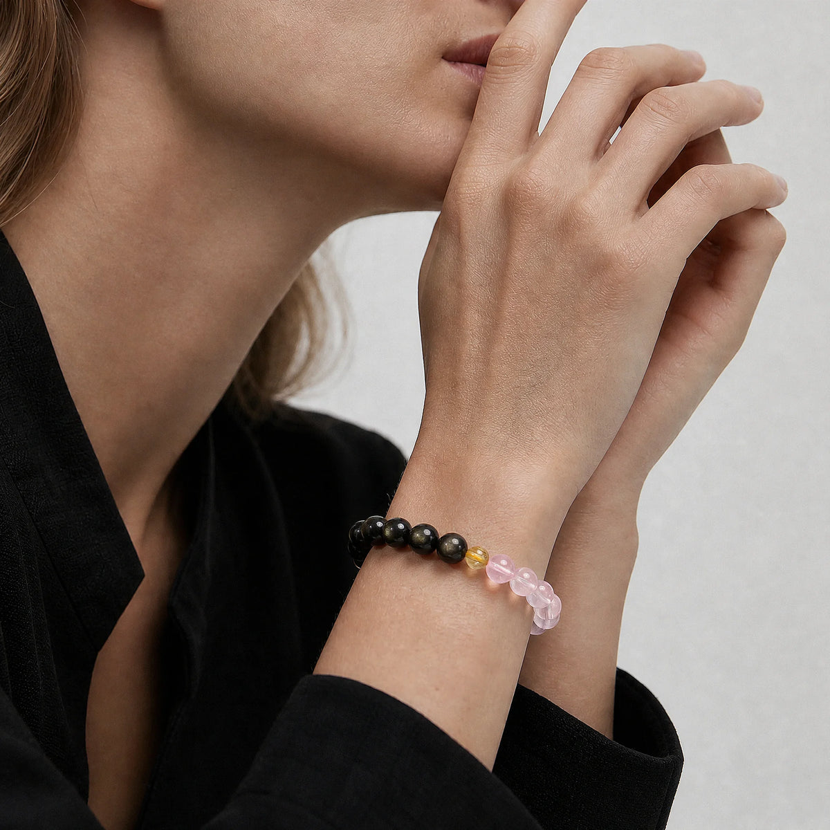 The Obsidian, Pink Quartz and Rutilated Quartz Bracelet close-up on the wrist, BE.