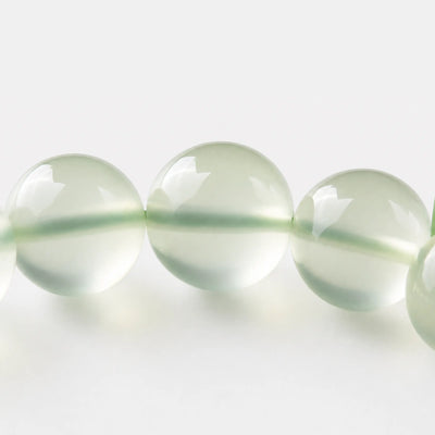 Prehnite Bracelet close-up — translucent green prehnite with dark epidote inclusions, BE.